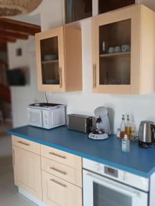 a kitchen with a blue counter top with appliances at Oléron côte ouest, 3 étoiles in La Cotinière