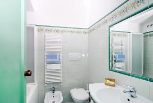 a bathroom with a sink and a toilet and a mirror at Hotel Le Terrazze in Conca dei Marini +37 photos