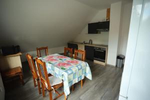 a kitchen with a table and chairs and a kitchen with a stove at Apartmán TINA in Rudolfov