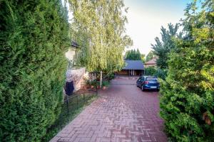 a brick road with a car parked in a driveway at Páros faház in Balatonföldvár