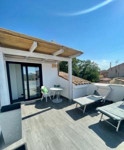 a patio with a table and chairs on a roof at Suite 29A Olbia Center in Olbia