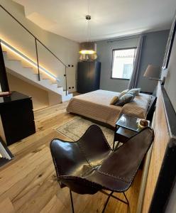 a bedroom with a bed and a desk and a chair at Suite 29A Olbia Center in Olbia +16 photos