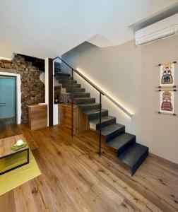 a staircase in a house with a stone wall at Suite 29A Olbia Center in Olbia
