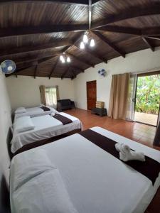 Una habitación con un montón de camas. en Hotel Catarata Río Celeste en Bijagua