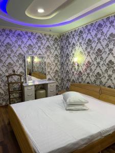 YakkasarayにあるHivaの紫の壁のベッドルーム1室(白いベッド1台付)