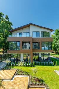 a house with a garden in front of it at Kraimorie Park in Burgas City