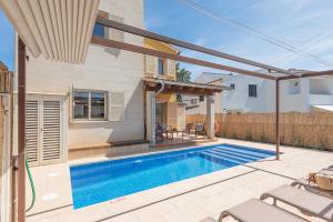 a swimming pool in the backyard of a house at Ca S'Ingles in Alcudia