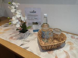 a bottle of wine in a basket on a table at Enzianbrenner in Jenig