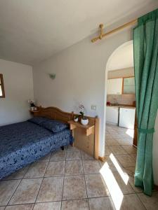 a bedroom with a bed and a table and a window at DOLOMITI house 1 in Fiera di Primiero