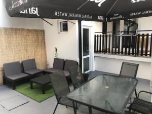 a patio with a table and chairs in a building at Apartmani Anja Ohrid in Ohrid