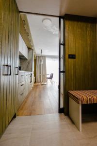 a hallway leading to a kitchen with a table at HILLHOME apartment & Sauna in Donovaly