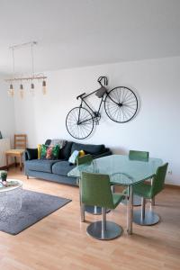 a bike hanging on a wall in a living room at HAPPY MAMA COLMAR with PARKING in Colmar