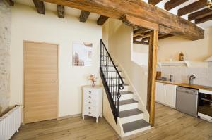 a kitchen with a spiral staircase in a loft at Le Logis du Beffroi in Sancerre