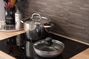 a pot sitting on top of a stove in a kitchen at HAPPY HOME COLMAR with PRIVATE PARKING in Colmar +21 photos