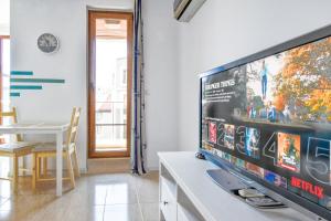 a living room with a large flat screen tv at Modern Studios - Meters away from the beach in Pomorie