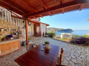 a patio with a table and a view of the ocean at Stefanel View-Frederika in Himare
