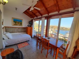 a bedroom with a bed and a table and chairs at Stefanel View-Frederika in Himare