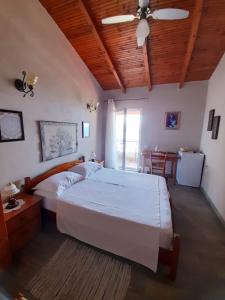 a bedroom with a large bed with a wooden ceiling at Stefanel View-Frederika in Himare