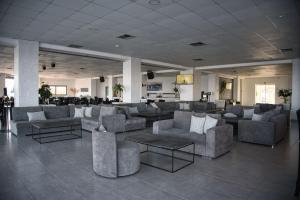 a lobby with couches and tables in a building at Royal Bay Suites in Kefalos
