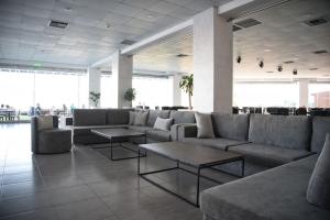 a lobby with couches and tables in a building at Royal Bay Suites in Kefalos