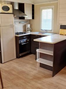 kuchnia z kuchenką i blatem w obiekcie Grand Mobile home dans camping w mieście Mimizan