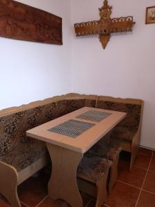 a wooden table and bench with a table and a couch at A summer house Zarabie Domek letniskowy Zarabie in Myślenice
