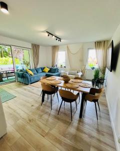a living room with a table and chairs and a couch at Apartament Przy Plaży Rewal in Rewal