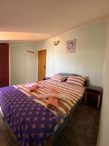 a bed in a room with towels on it at Sunny Villa Apartments in Budva