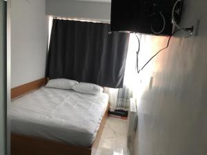 a small bedroom with a bed and a window at NR1 HOTEL in Çanakkale