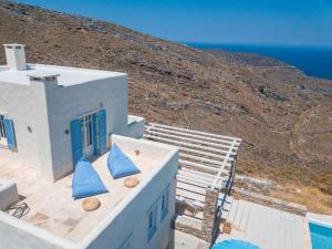 a building with blue pillows sitting on top of it at Kea Ciel Villa in Ioulis