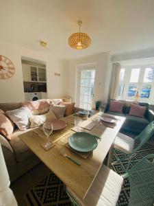 a living room with a table and a couch at Coastal 2 bedroom maisonette with parking in Eastbourne