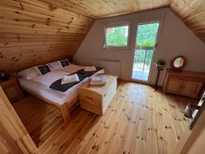 a bedroom with a bed in a wooden room at Chalupa v prírode in Pliešovce