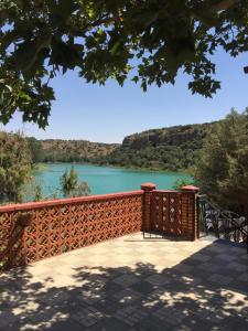 a wooden fence with a view of a river at La Buena Siesta in Ruidera