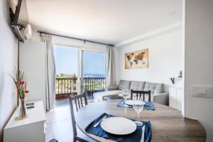 a dining room with a table and a view of the ocean at Ocean and Siam Park view Home by LoveTenerife in Adeje