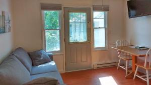 a living room with a couch and a table at The Village Motel in Naramata