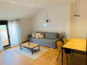 a living room with a couch and a table at Apartamentos Best Ainsa in Aínsa