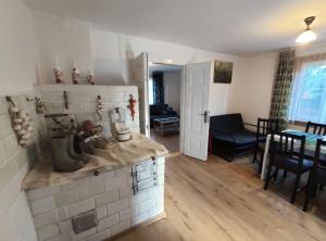 a living room with a kitchen and a dining room at Domek babci Marysi in Krasnobród
