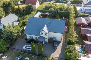 an aerial view of a house with a blue roof at Willa Puchatek in Gąski