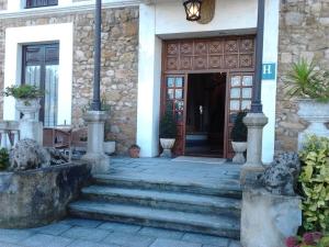 a front door of a house with stairs leading to it at Hotel Luzon in San Vicente de la Barquera +24 photos