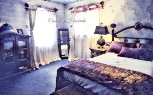 a bedroom with a bed and a window with curtains at Ex Hacienda Hostal in Guanajuato