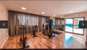 a gym with treadmills and exercise bikes in a room at Flat Beira Mar - Piedade in Recife
