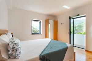 a bedroom with a bed and a large window at DouroParadise in Peso da Régua +42 photos