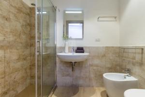 a bathroom with a sink and a shower at Rooms Best Vacation Ever in Cagliari +16 photos