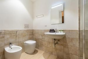 a bathroom with a toilet and a sink at Casa Vacanza Home MAF in Cagliari