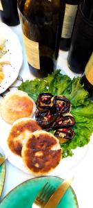 a plate of food with mussels and lettuce on a table at dimis ferdobi in Dimi