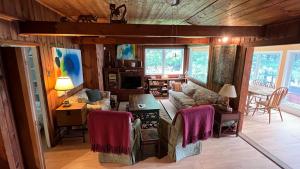 a living room with a couch and a table at Lakeside Cottage in Wentworth