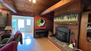 a living room with a fireplace and a brick wall at Lakeside Cottage in Wentworth