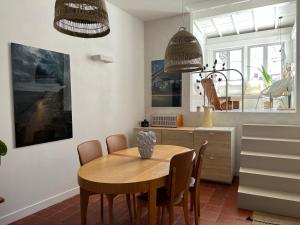 a dining room with a wooden table and chairs at Penthouse Apartment with Large Terrace and Veranda in Arles