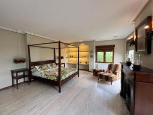a bedroom with a canopy bed and a chair at Villa Ca Toni in Alicante +59 photos