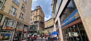 a city street with tall buildings and a blue umbrella at Asboth Boutique Budapest in Budapest